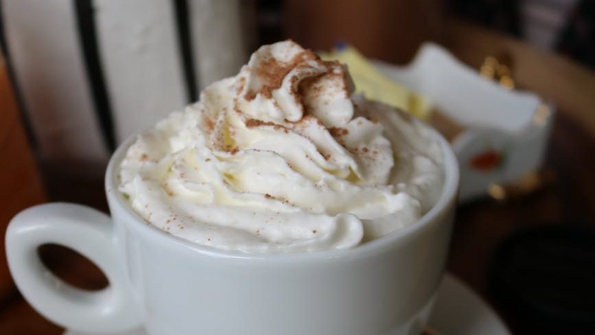 white ceramic cup with white cream