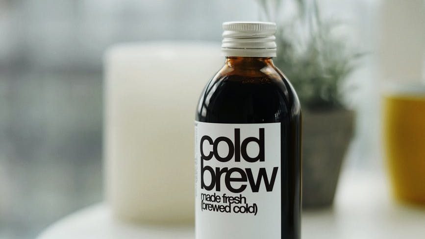 a black and white labeled bottle on the table